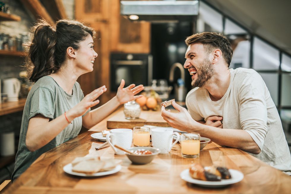 cheerful-couple-talking-during-breakfast-at-home-royalty-free-image-1626859353