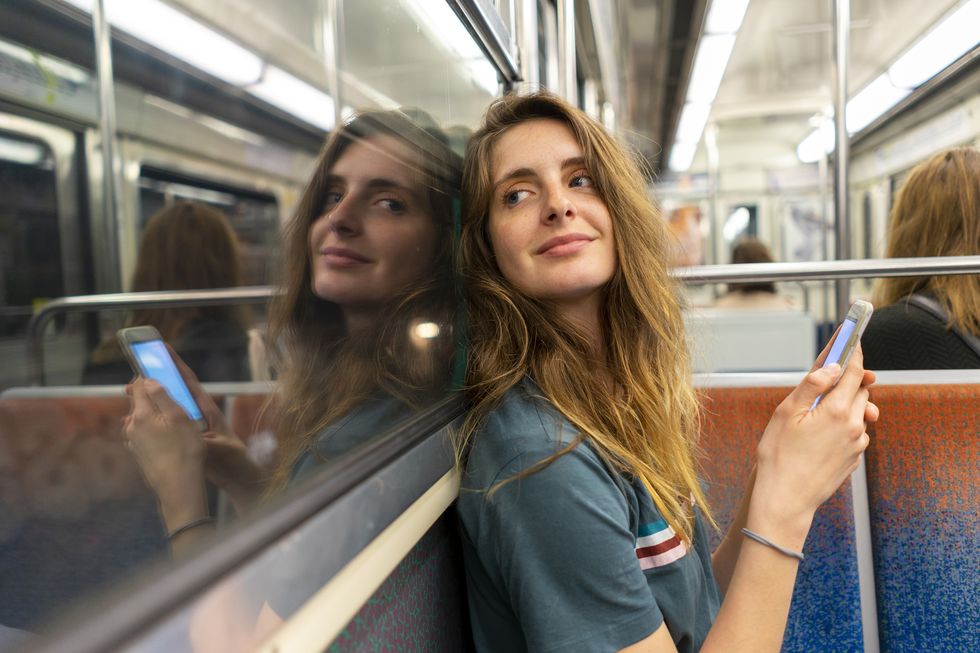 portrait-of-smiling-young-woman-and-her-mirror-royalty-free-image-1023301722-1557735721-1